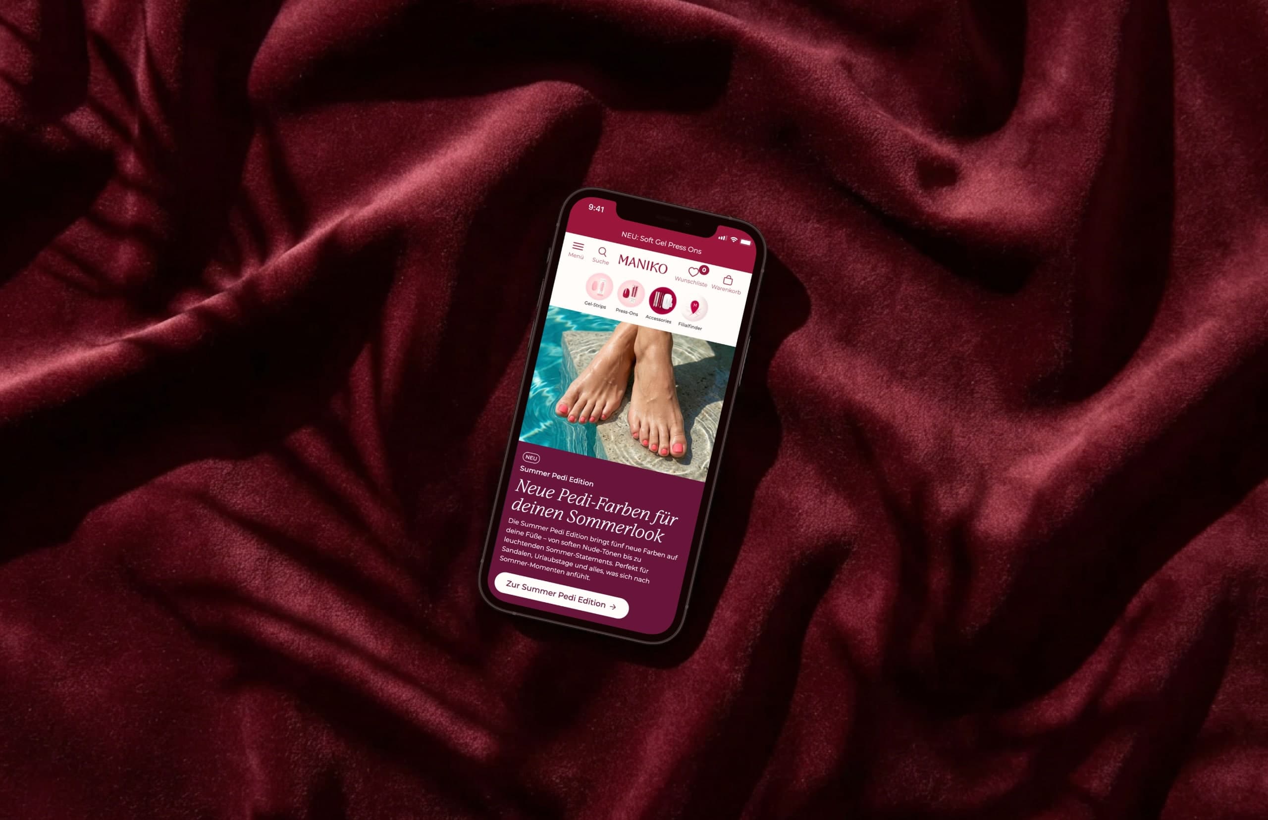 The Maniko Nails store on a phone lying on dark-red velvet